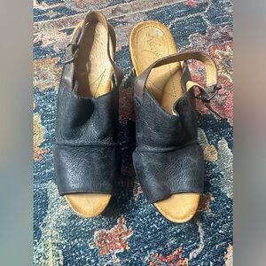 Naya black leather wedges